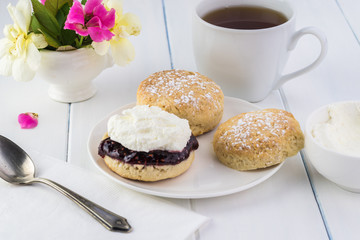 Traditional English cream tea. English scones with clotted cream and raspberry jam.
