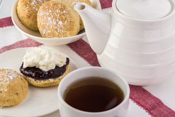 Traditional English cream tea. English scones with clotted cream ans raspberry jam.