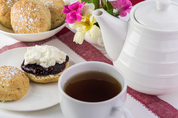 Obraz na płótnie Canvas Traditional English cream tea. English scones with clotted cream ans raspberry jam.