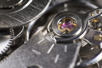 Macro detail of the ruby ​​in the mechanism of a wristwatch / Extreme close up of the inside of a wristwatch case