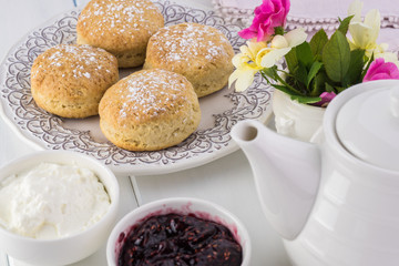 Traditional English cream tea. English scones with clotted cream and raspberry jam.