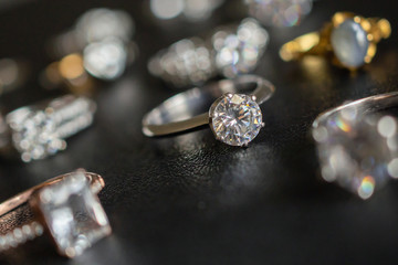 Jewelry diamond rings on black background close up
