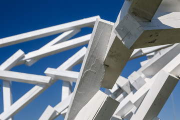 Abstract wooden structure against a blue sky