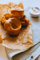 Yorkshire pudding with smoked salmon and sour cream on baking paper