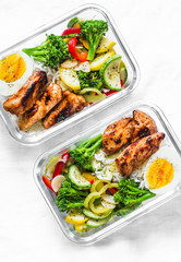 Rice, stewed vegetables, egg, teriyaki chicken - healthy balanced lunch box on a light background, top view
