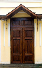 Texture of a wooden door with a triangular roof. Close-up, Background