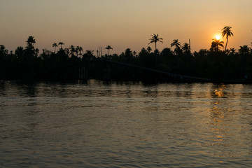 Naklejka premium Beautiful sunset view from a boat ride at Alappuzha, Kerala, India