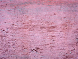Texture of a shabby old violet wall. Close-up. Building background.