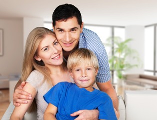 Obraz premium Beautiful smiling family sitting at sofa at home