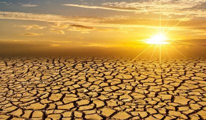 arid Clay soil Sun desert global worming concept cracked scorched earth soil drought desert landscape dramatic sunset