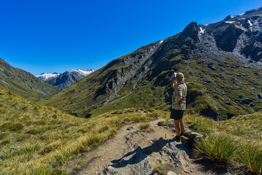 Hiker taking a water break, Rees Saddle, Rees-Dart Track, Mt Aspiring National Park, South Island, New Zealand