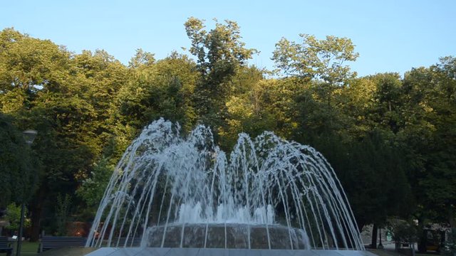 Fountain in a public park in Vrnjacka Banja, Serbia, changing shapes of spraying water, early in the morning