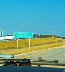 Road sign - 45th Parallel in Michigan, North America. Unique marker is separating the north pole and the equator, mean middle of geographic coordinates.