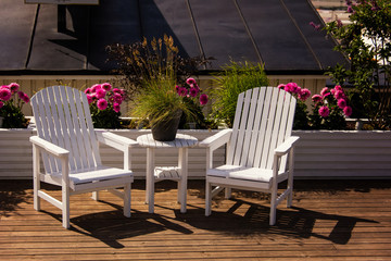Fototapeta na wymiar white garden furniture on a yacht. Place for relax. Lykke in Stockholm, Sweden