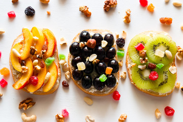 different homemade cooked sandwiches with fruits and berries on white background closeup