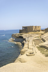 Fototapeta na wymiar Qolla l-Bajda known as White Hillock is old medieval battery built by Saint John on island Gozo in city Zebbug. Artillery ruins.