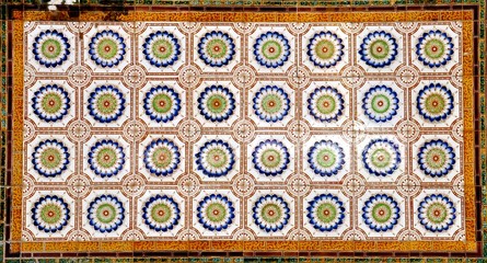 Mosaic of colourful ornate floral ceramic tiles typical of designs found on the frontage of traditional Chinese peranakan shop houses	