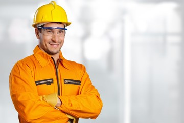 Young man in work uniform and yellow helmet