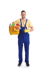 Male janitor with cleaning supplies on white background