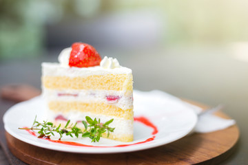 closeup of delicious strawberry cake with leaf and fruit on top