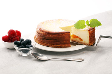 Homemade cheesecake with fresh raspberries and mint for dessert - healthy organic summer dessert pie cheesecake. Vanilla Cheese Cake
