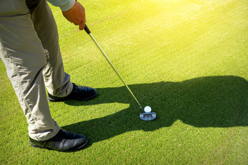 man playing Golf on green grass