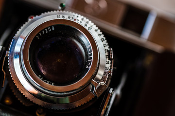 Close up of aperture ring of antique camera lens on Dark Background