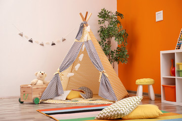 Cozy kids room interior with play tent and toys © New Africa