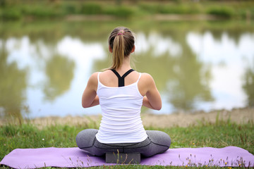 Yoga exercises outdoors / A young girl / Portrait