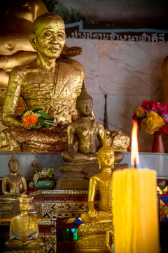 Buddha praying candle flame fire flowers wat temple chiang mai thailand