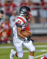 Football player running with the ball during a game