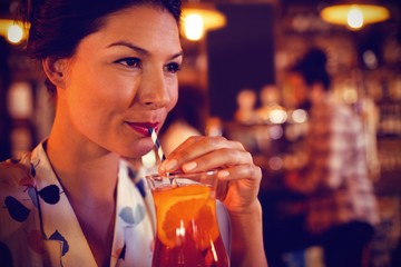 Young woman having cocktail drink