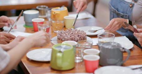 Family having cake together in coffee shop
