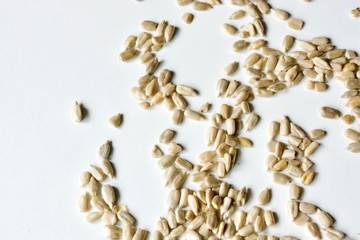 Tasty raw sunflower seeds on the white background