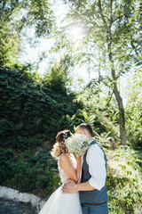 Fototapeta premium bride and groom together holding wedding bouquet