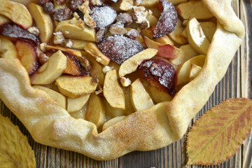 Homemade galette with apples plums and nuts