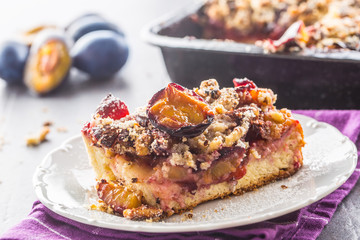 The traditional sweet plum cake on white plate