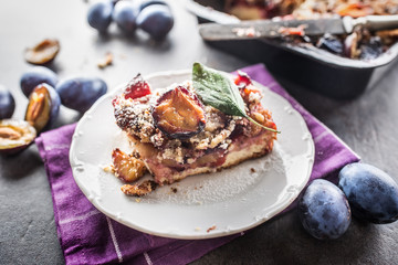 The traditional sweet plum cake on white plate