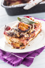 The traditional sweet plum cake on white plate