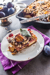 The traditional sweet plum cake on white plate