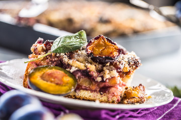 The traditional sweet plum cake on white plate
