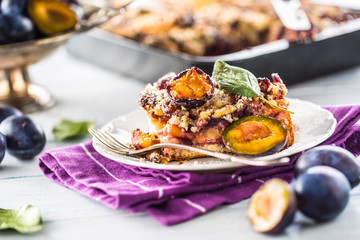 The traditional sweet plum cake on white plate