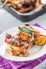 The traditional sweet plum cake on white plate