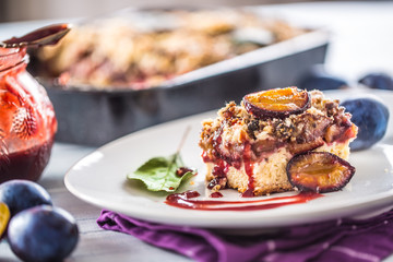 The traditional sweet plum cake on white plate