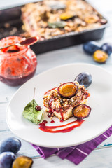 The traditional sweet plum cake on white plate