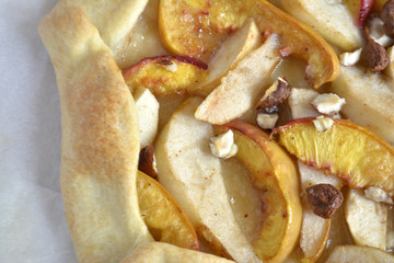 Homemade galette with different fruits with pears, peaches and nuts