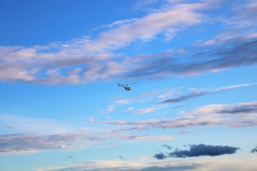 Helicopter flying after the passing sun