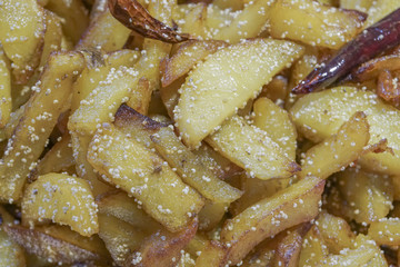 Fried potato pieces with fried red chilly