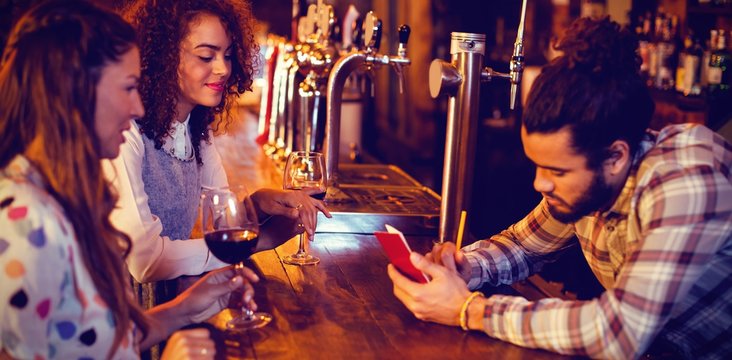 Bartender taking an order on notepad at counter