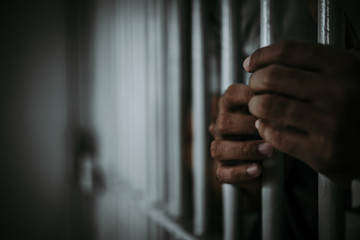 Obraz premium Hands of men desperate to catch the iron prison,prisoner concept,thailand people,Hope to be free.